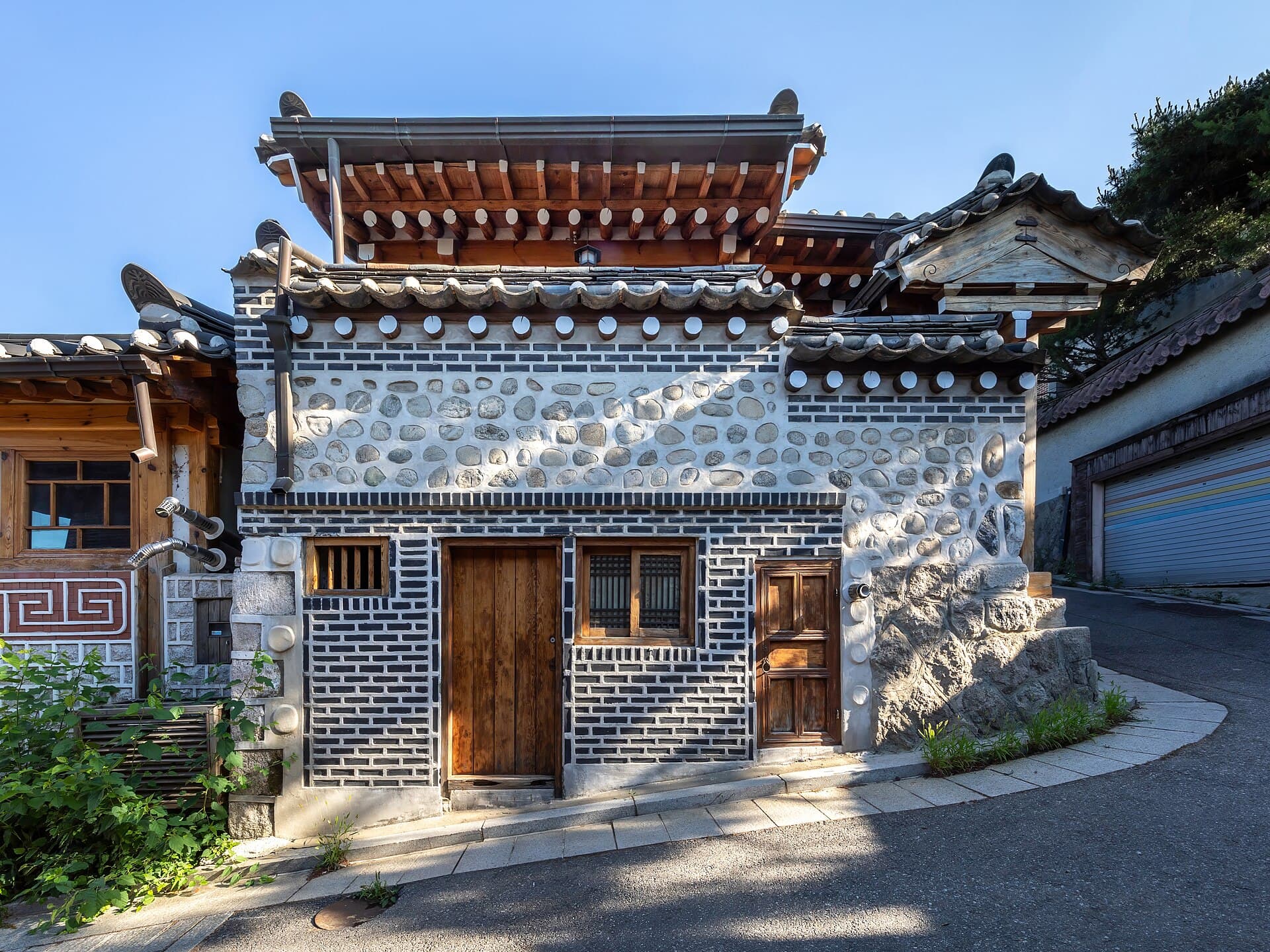 A wooden hanok frontage on a sloping street in Bukchon, Seoul