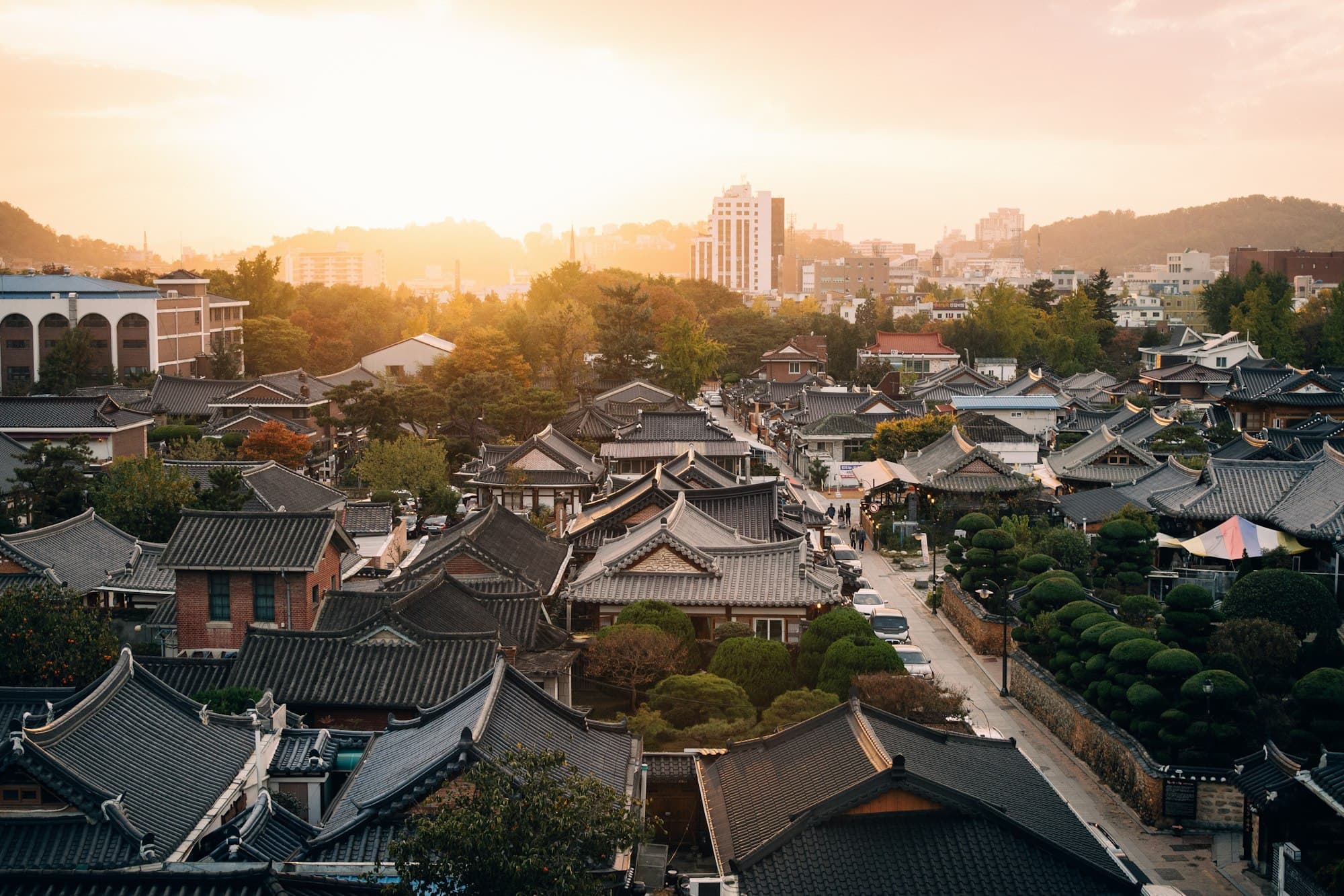 Traditional hanok rooftops in warm evening light at Jeonju Hanok Village